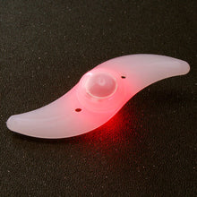 Load image into Gallery viewer, Two LED lights clipped to bicycle spokes, glowing in multiple colours to improve night visibility.