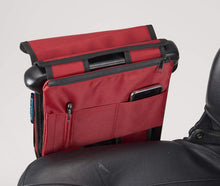 Load image into Gallery viewer, Red Ducksback mobility scooter pannier bag with zip pocket and phone storage, mounted behind the armrest.