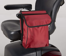 Load image into Gallery viewer, Red Ducksback pannier bag attached to a mobility scooter armrest, providing side storage for personal items.