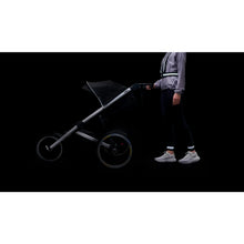 Load image into Gallery viewer, Bookman black reflective bands worn around the ankles during an outdoor walk for enhanced visibility.
