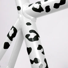 Load image into Gallery viewer, Close-up of black leopard-pattern reflective stickers applied to a white bicycle frame.
