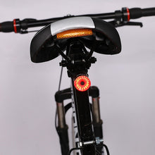 Load image into Gallery viewer, Black replacement mounting bracket attached to a bicycle handlebar, holding CushBike Flare Recon LED light and waterproof powerbank.