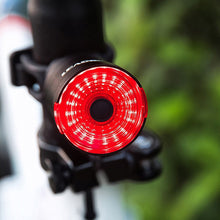 Load image into Gallery viewer, Black replacement mounting bracket attached to a bicycle handlebar, holding CushBike Flare Recon LED light and waterproof powerbank.
