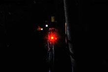 Load image into Gallery viewer, CushBike 300‑Lumen rechargeable bicycle tail light mounted on a seatpost — bright LED, waterproof aluminium body, quick‑release strap for bike, helmet or backpack