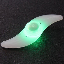 Load image into Gallery viewer, Two LED lights clipped to bicycle spokes, glowing in multiple colours to improve night visibility.
