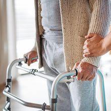 Load image into Gallery viewer, Side-by-side comparison showing a standard walker handle without cushioning and the same handle with padded grip cover installed, emphasizing increased comfort and reduced pressure on hands.
