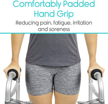 Load image into Gallery viewer, Black padded hand grip covers securely installed on a folding walker handle, demonstrating ergonomic comfort, non-slip fit, and improved hand support during mobility use.
