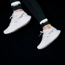 Load image into Gallery viewer, Bookman fluorescent yellow reflective bands worn around the ankles for enhanced cycling and outdoor visibility.
