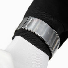 Load image into Gallery viewer, Close-up of a Bookman black slap wrap showing its silver reflective strip around the band.
